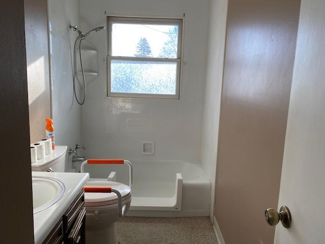 bathroom featuring shower / tub combination, vanity, and toilet