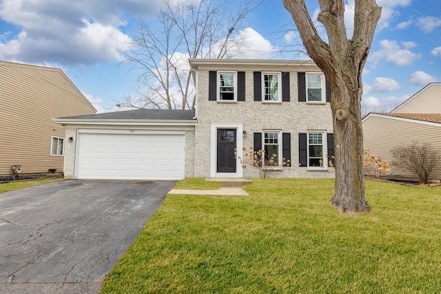 colonial inspired home featuring an attached garage, a front lawn, aphalt driveway, and brick siding