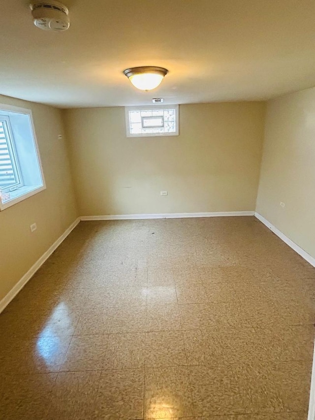 empty room with tile patterned floors and baseboards