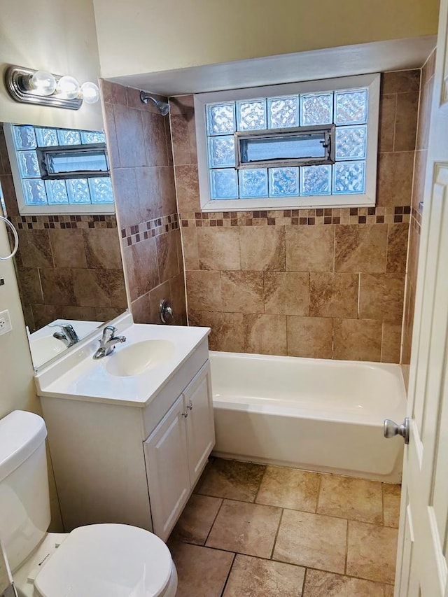 bathroom featuring plenty of natural light, vanity, and toilet