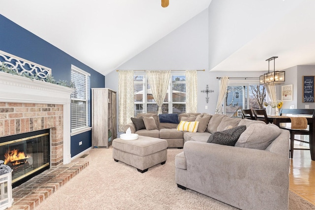 living room featuring high vaulted ceiling and a fireplace