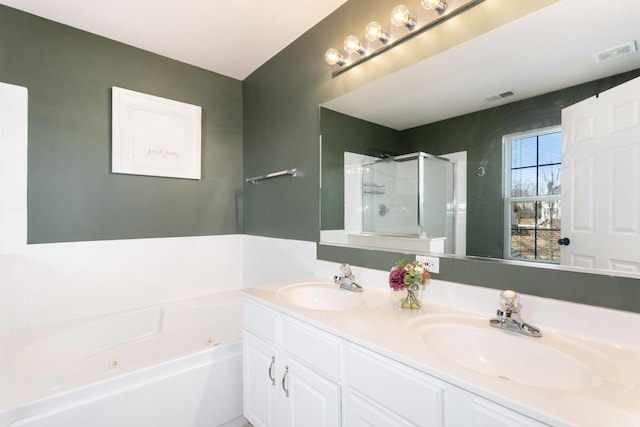 bathroom with a sink, visible vents, and a shower stall