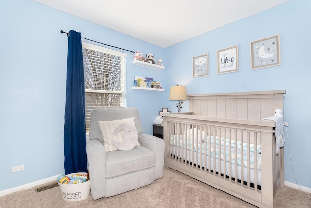 bedroom with baseboards, a crib, visible vents, and carpet flooring