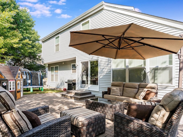 view of patio featuring grilling area, a trampoline, and outdoor lounge area