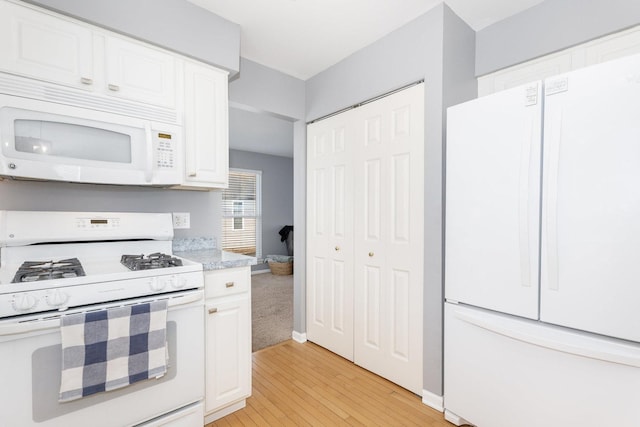 kitchen with baseboards, white appliances, white cabinetry, and light wood-style floors