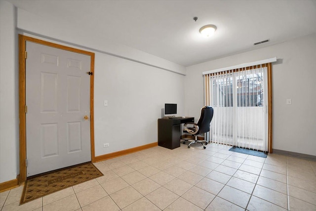 home office featuring light tile patterned flooring, visible vents, and baseboards