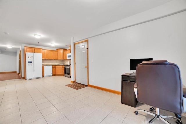 home office with light tile patterned floors and baseboards