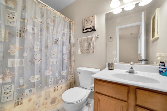 bathroom featuring curtained shower, vanity, and toilet