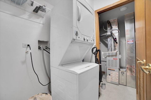 washroom with laundry area and stacked washing maching and dryer