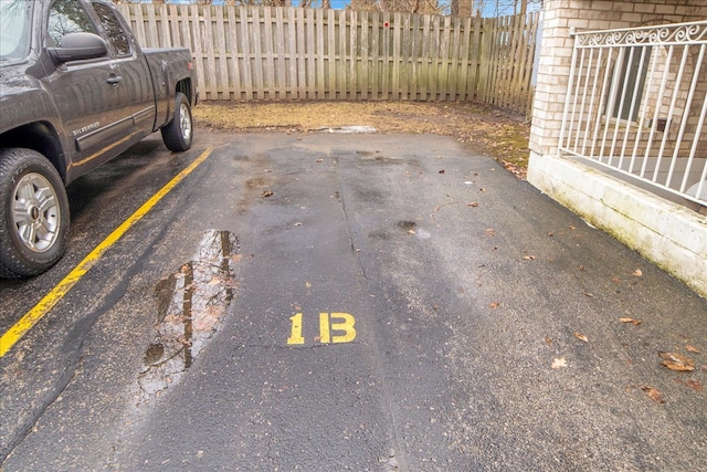 exterior space featuring uncovered parking and fence