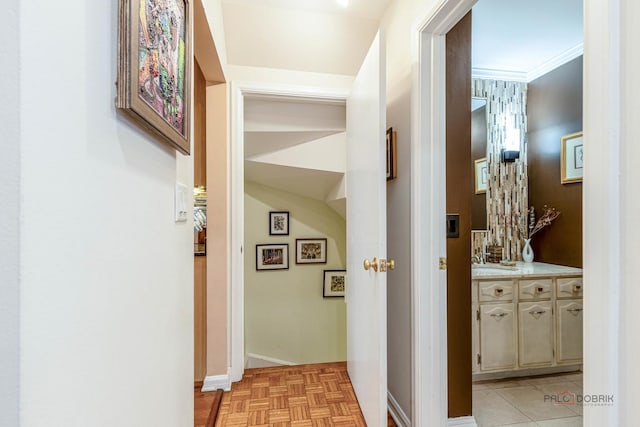 corridor featuring baseboards and crown molding