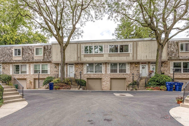 view of property with an attached garage and driveway