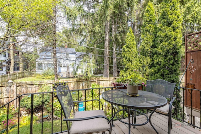 view of wooden balcony with outdoor dining area and a deck