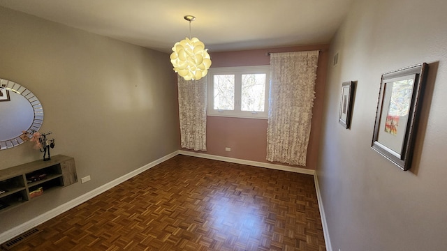 unfurnished dining area with a chandelier, visible vents, and baseboards