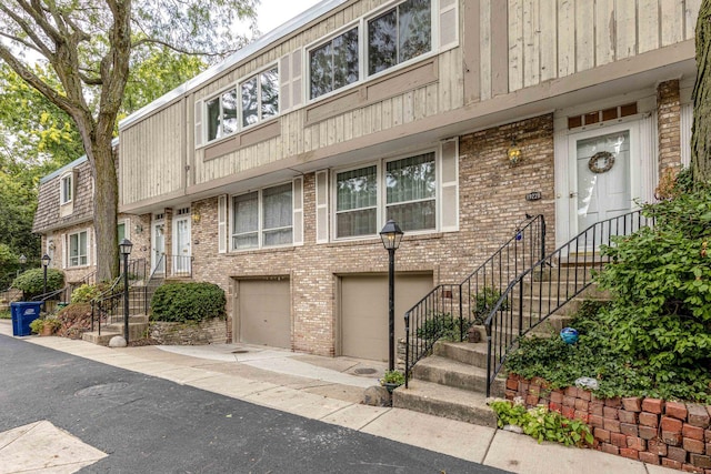 exterior space featuring brick siding and an attached garage