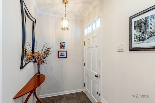 foyer entrance with crown molding, baseboards, and a chandelier