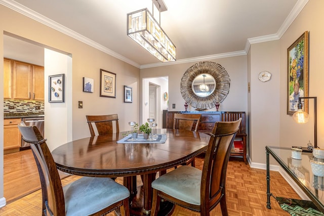 dining room featuring crown molding, parquet flooring, and baseboards