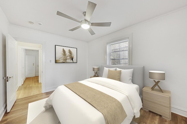 bedroom featuring baseboards, a ceiling fan, and light wood-style floors