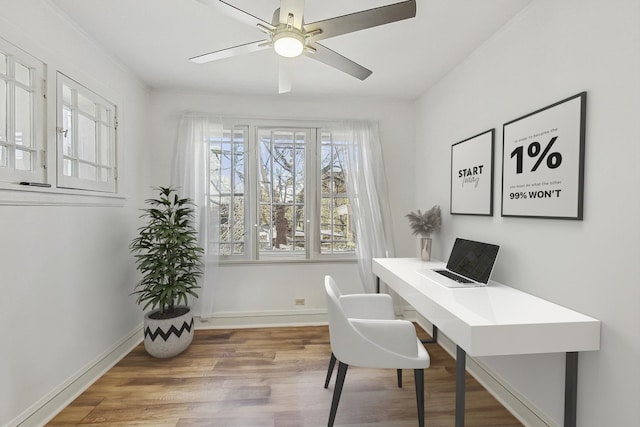 home office with a ceiling fan, baseboards, and wood finished floors