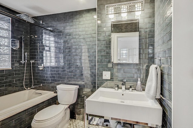 full bath featuring tiled shower / bath combo, a sink, tile walls, and toilet