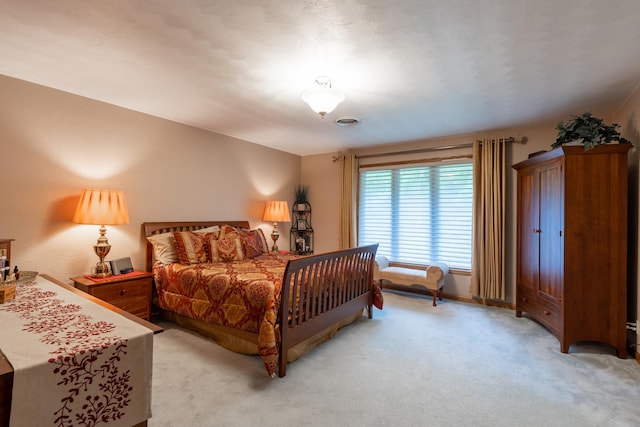 bedroom featuring visible vents, light carpet, and baseboards