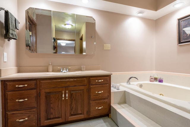 bathroom with a garden tub and vanity