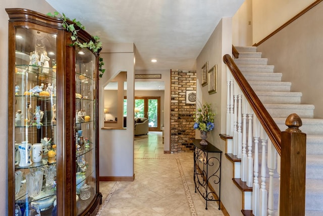 entryway with stairway and baseboards