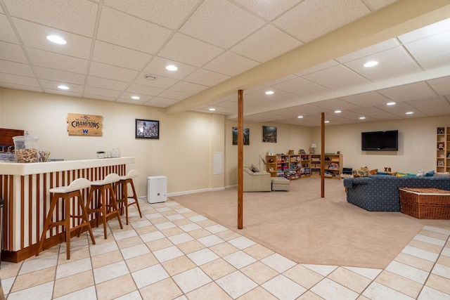 bar with tile patterned floors, recessed lighting, a bar, and carpet