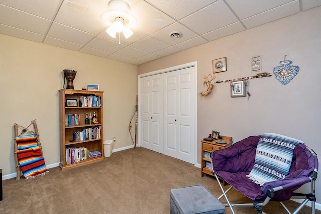 sitting room featuring carpet flooring, a paneled ceiling, visible vents, and baseboards