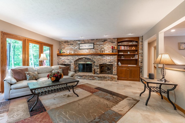 living room with built in features, baseboards, a textured ceiling, and a brick fireplace