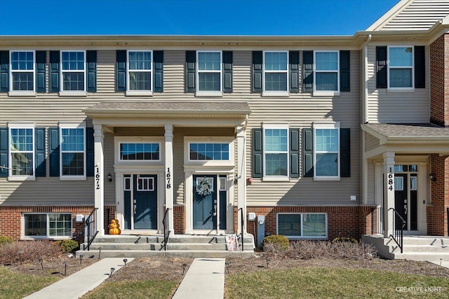 townhome / multi-family property with brick siding