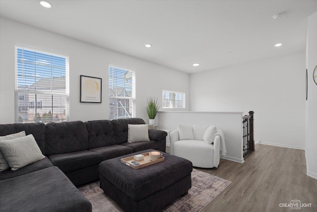 living area featuring baseboards, recessed lighting, and light wood-style floors