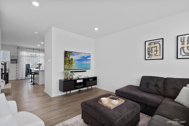 living room with baseboards, recessed lighting, and wood finished floors