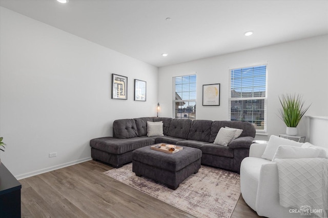 living room featuring baseboards, recessed lighting, and wood finished floors