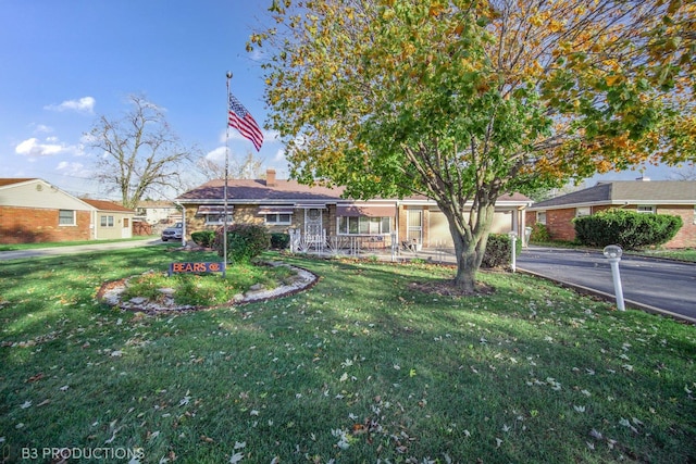 ranch-style house featuring a chimney and a front yard