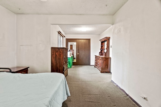 bedroom featuring a textured ceiling and carpet floors