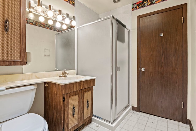 full bath featuring a stall shower, vanity, and toilet