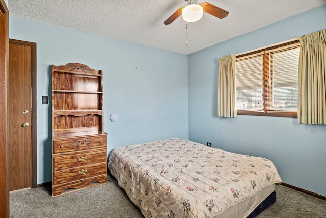 bedroom with a textured ceiling, carpet, and baseboards