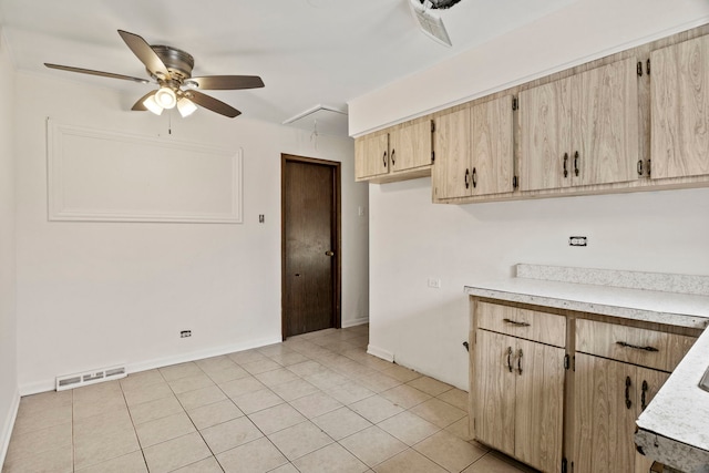 kitchen featuring light brown cabinetry, visible vents, light countertops, and light tile patterned flooring