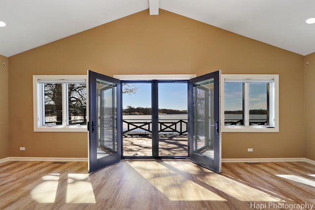 doorway to outside featuring wood finished floors, plenty of natural light, and french doors