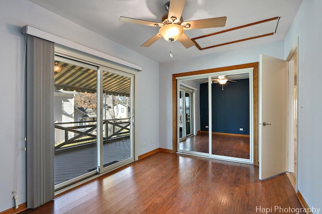 unfurnished room featuring a ceiling fan, baseboards, and wood finished floors