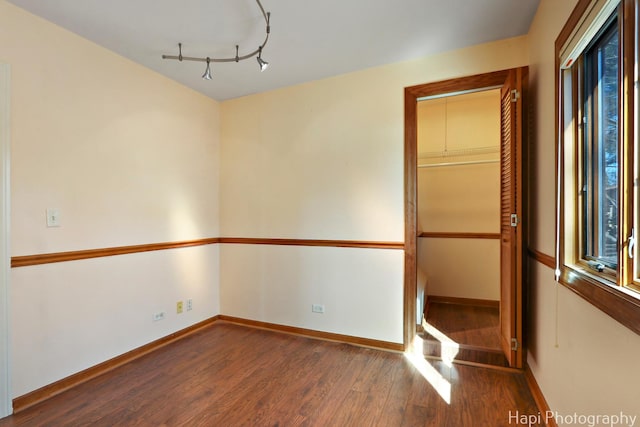 spare room with wood finished floors and baseboards