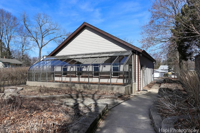 rear view of property with an outbuilding and an exterior structure