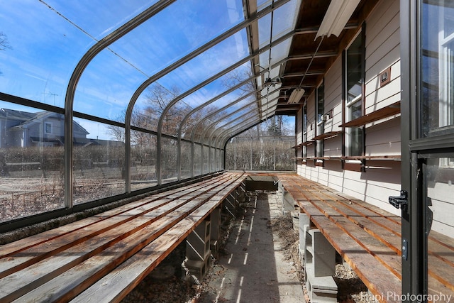 unfurnished sunroom with vaulted ceiling