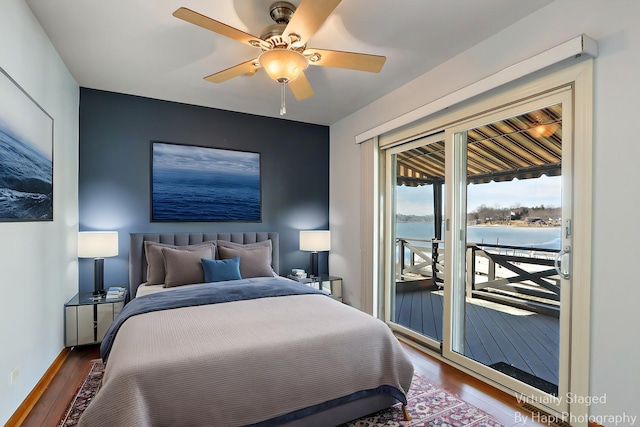 bedroom with access to exterior, dark wood-style floors, and a ceiling fan