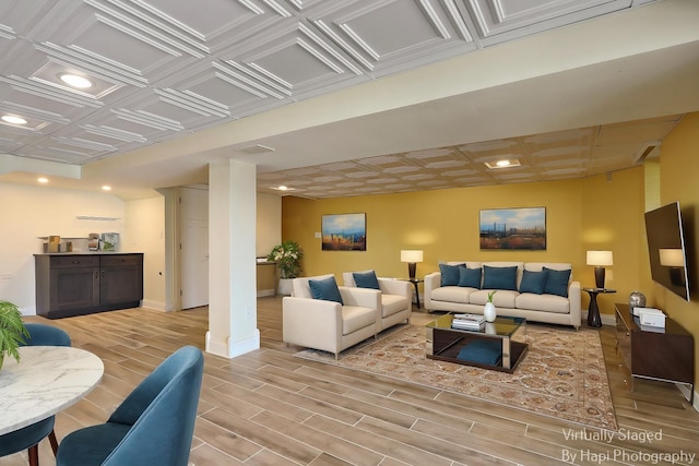 living area with wood finish floors, baseboards, and recessed lighting