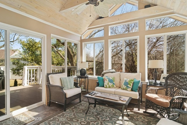 sunroom with lofted ceiling, wood ceiling, a ceiling fan, and a wealth of natural light