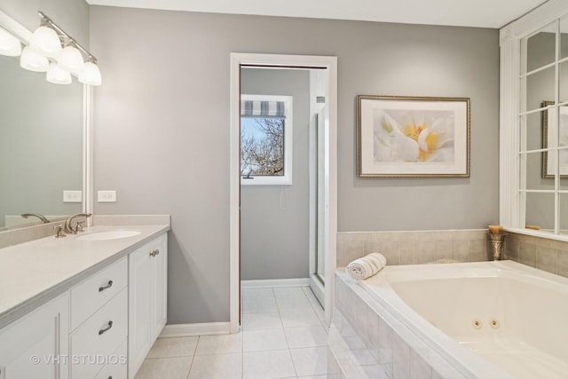 full bathroom featuring tile patterned floors, baseboards, a jetted tub, and vanity