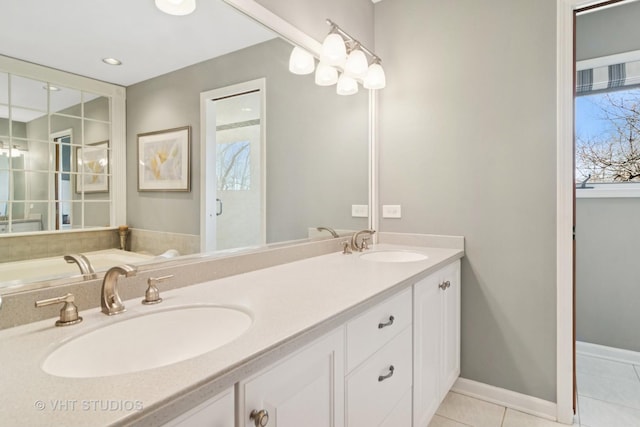 bathroom featuring tile patterned flooring, double vanity, baseboards, and a sink