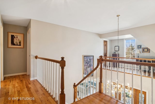 stairway featuring baseboards and wood finished floors